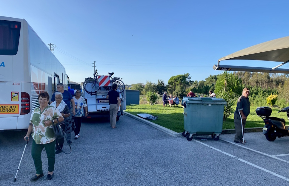 surrounded by a bus full of pensioner pilgrims at a pingo doce parking lot